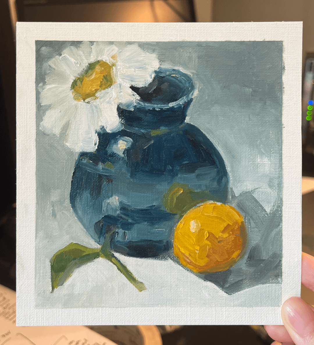 Painting of a blue vase with a white flower